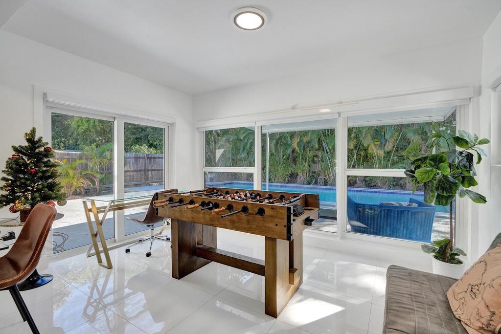 1050 Northeast 150th Street Miami, FL 33161 - Photo 24 of 50 a living room with furniture and a large window