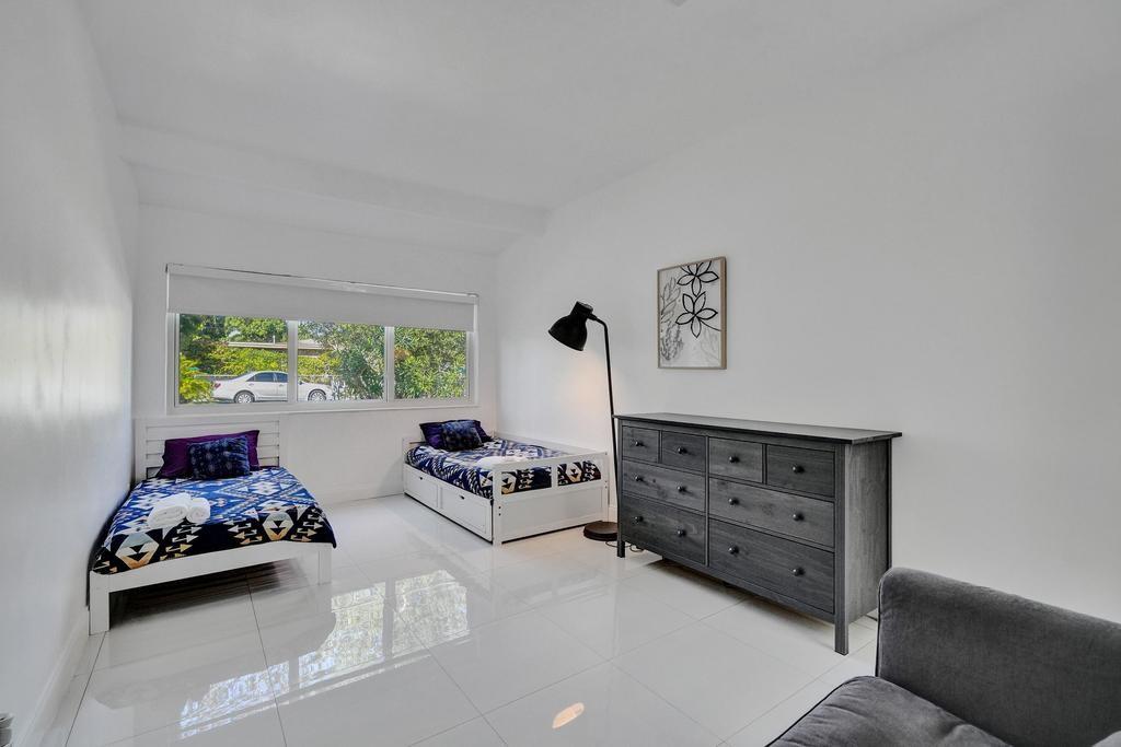 1050 Northeast 150th Street Miami, FL 33161 - Photo 32 of 50 a bedroom with furniture and a window