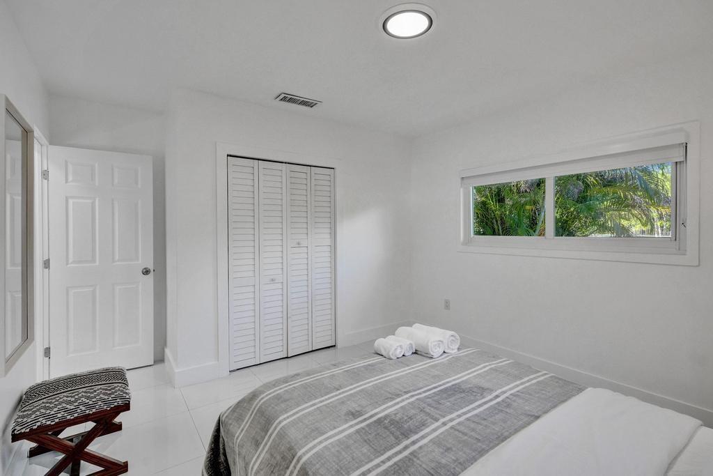 1050 Northeast 150th Street Miami, FL 33161 - Photo 33 of 50 a bedroom with a bed and a window