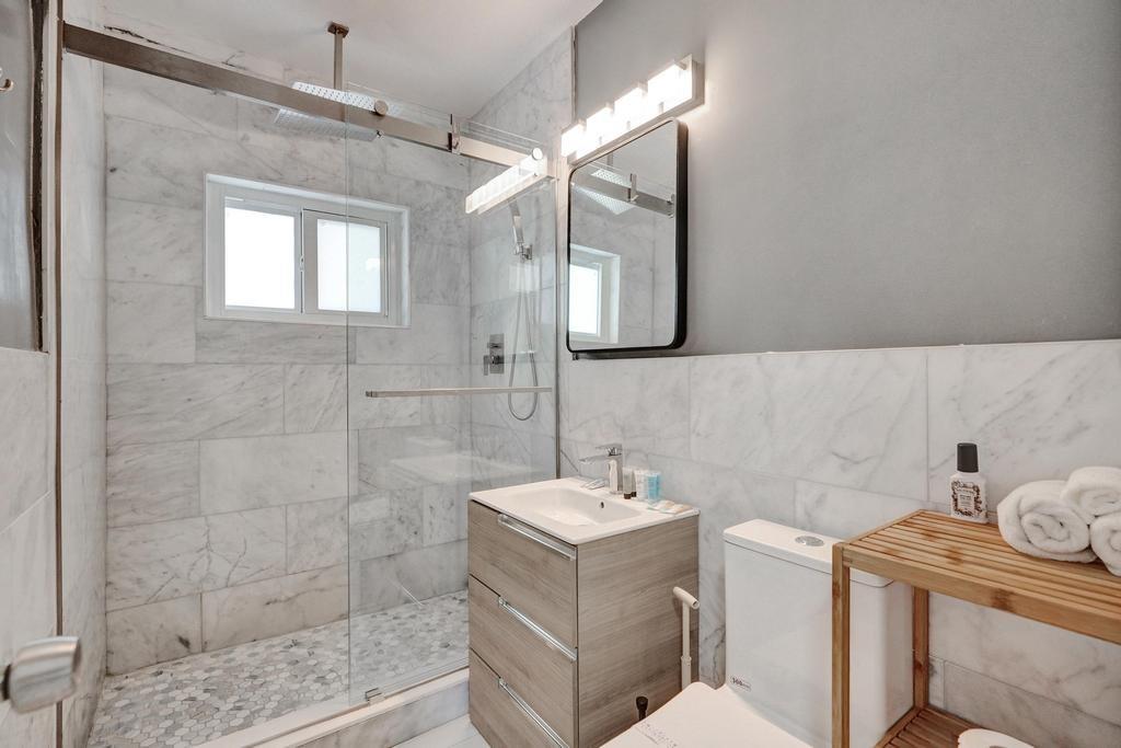 1050 Northeast 150th Street Miami, FL 33161 - Photo 35 of 50 a bathroom with a sink toilet and shower