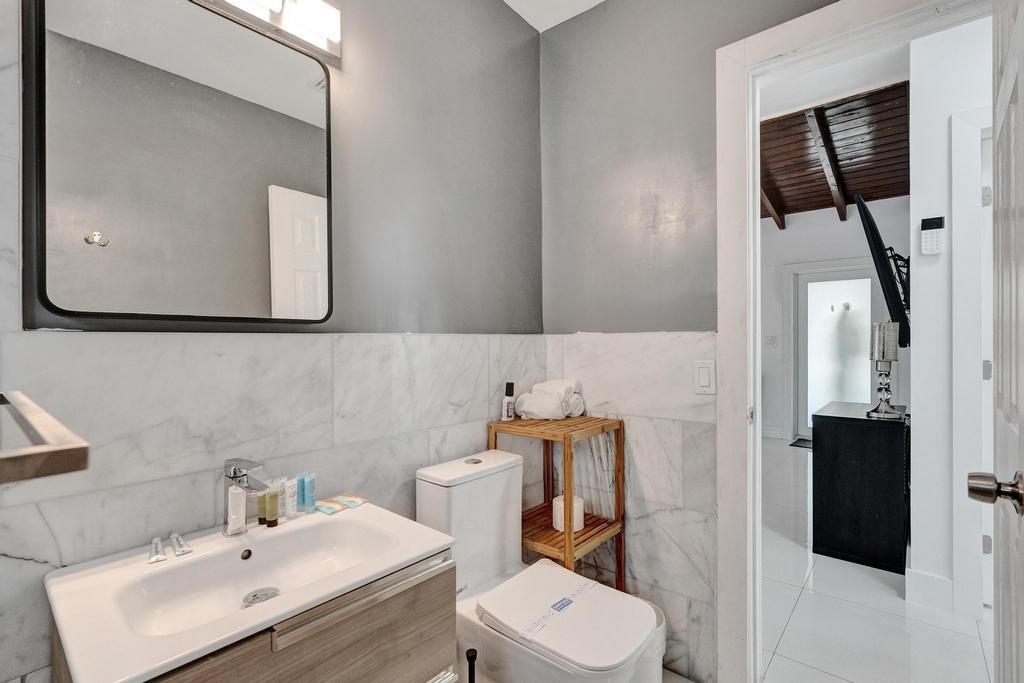 1050 Northeast 150th Street Miami, FL 33161 - Photo 36 of 50 a bathroom with a toilet sink and mirror