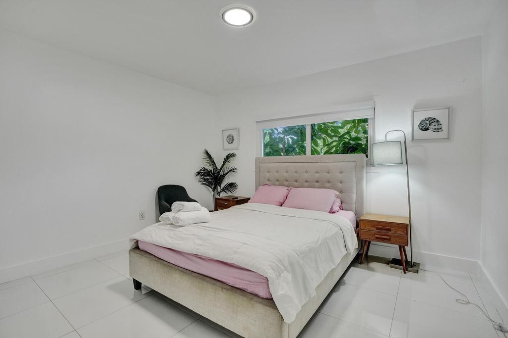 1050 Northeast 150th Street Miami, FL 33161 - Photo 37 of 50 a bedroom with a bed and a window