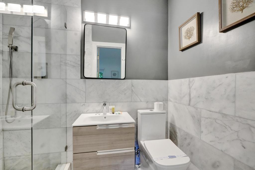 1050 Northeast 150th Street Miami, FL 33161 - Photo 41 of 50 a bathroom with a toilet a sink and mirror