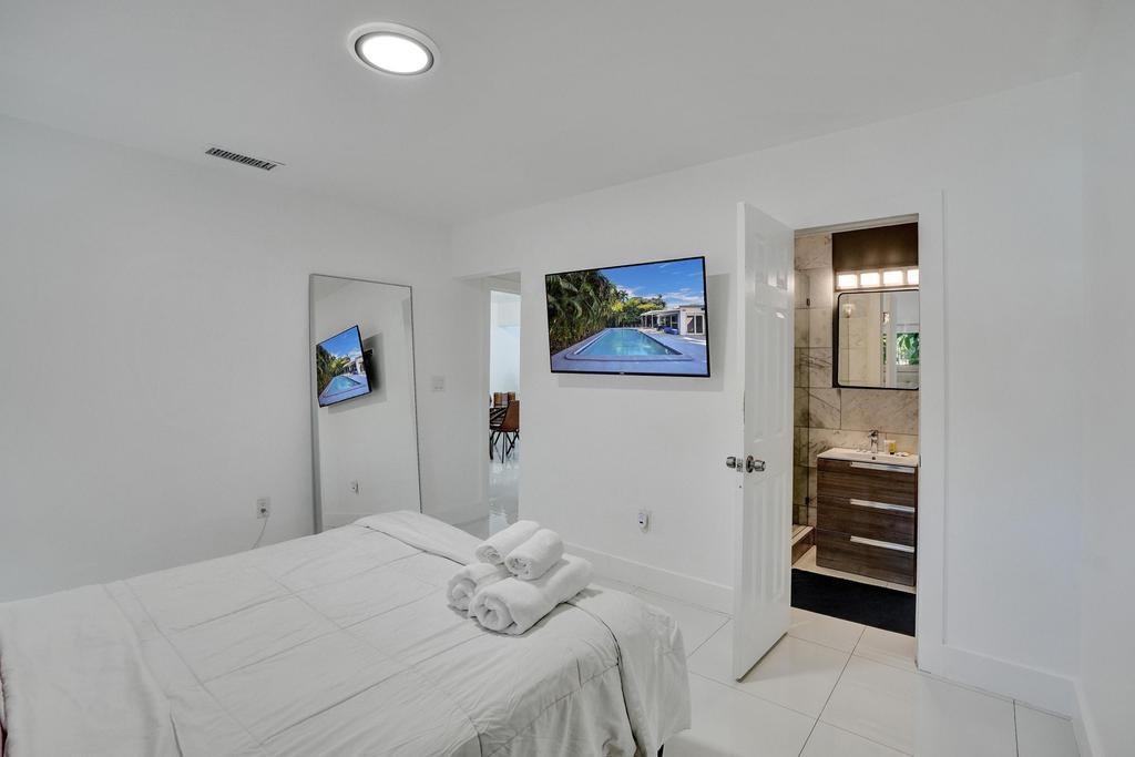 1050 Northeast 150th Street Miami, FL 33161 - Photo 42 of 50 a bedroom with a bed and a cabinets