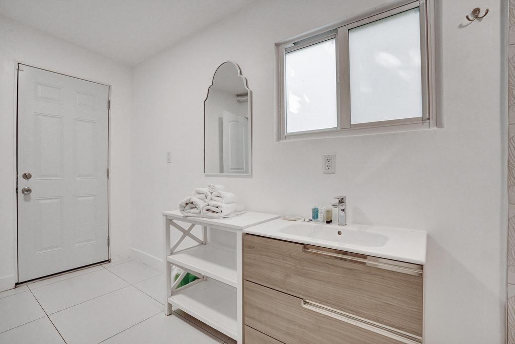 1050 Northeast 150th Street Miami, FL 33161 - Photo 44 of 50 a bathroom with a sink a vanity and a mirror