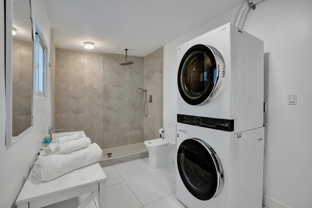 1050 Northeast 150th Street Miami, FL 33161 - Photo 45 of 50 a bathroom with a washer and a dryer