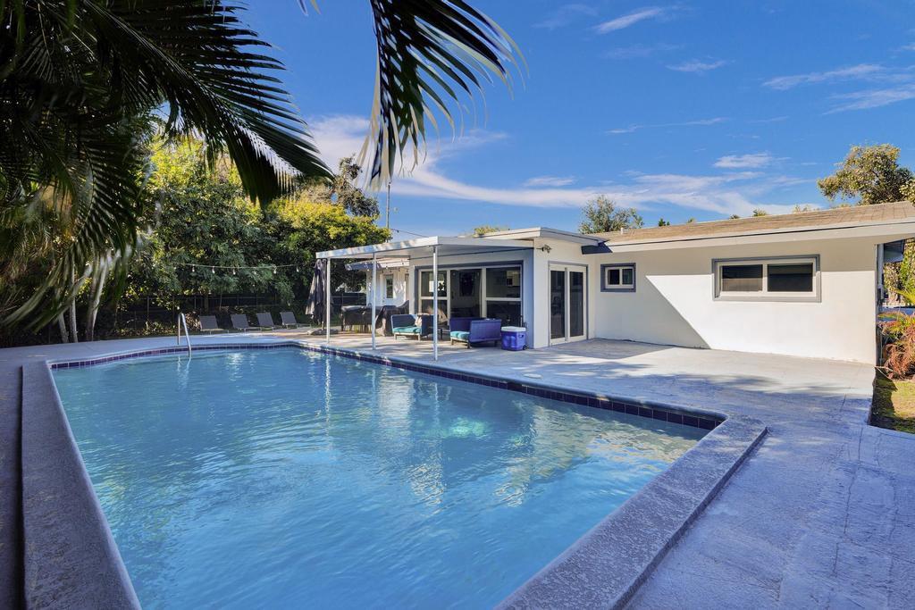 1050 Northeast 150th Street Miami, FL 33161 - Photo 47 of 50 a view of a house with pool and sitting area