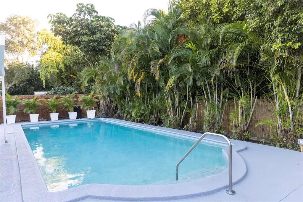 1050 Northeast 150th Street Miami, FL 33161 - Photo 48 of 50 a view of a backyard with swimming pool