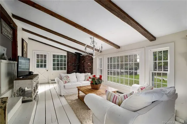 a living room with furniture fireplace and flat screen tv