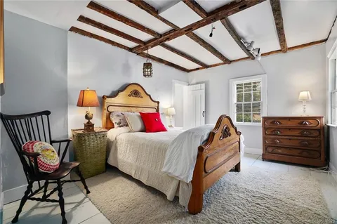 a bed room with a bed and a chair