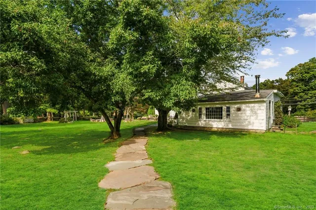 a front view of a house with a garden