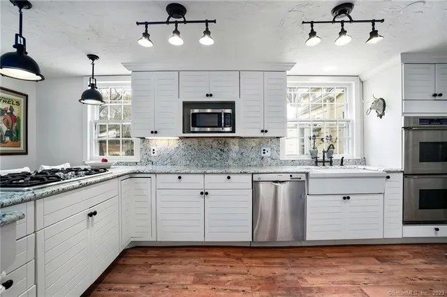 a kitchen with a stove window and cabinets
