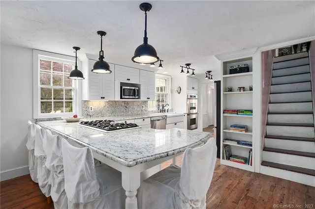 a kitchen with granite countertop a stove and a refrigerator