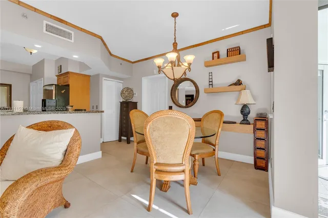 a dining room filled with furniture and a chandelier