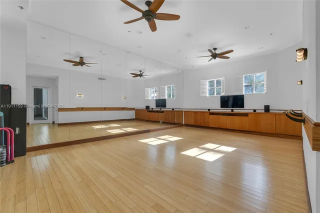 a view of a swimming pool with chairs and plants