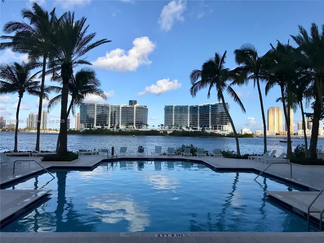 a view of a house with a patio and a yard
