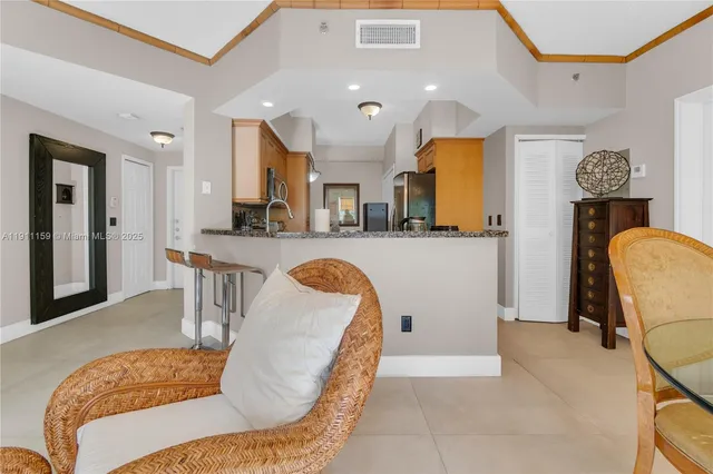 a living room filled with furniture and a chandelier