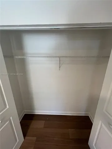 a view of a room with wooden floor