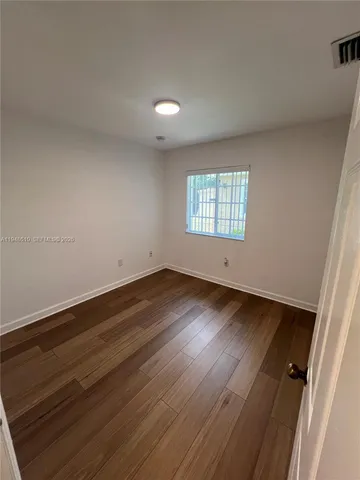 an empty room with wooden floor