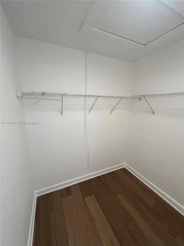 a view of hallway with furniture and wooden floor