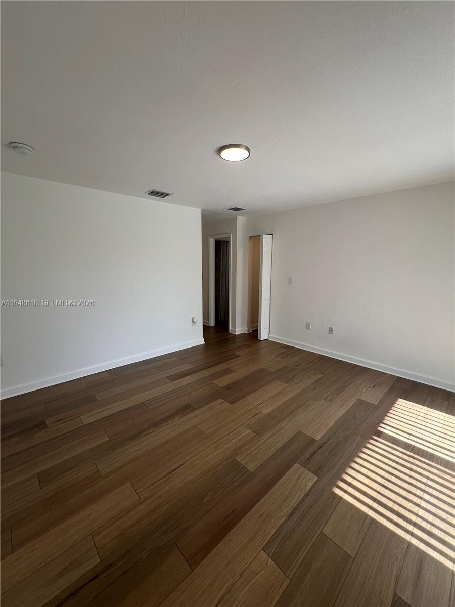 12254 Southwest 217th Street Miami, FL 33170 - Photo 24 of 40 an empty room with wooden floor