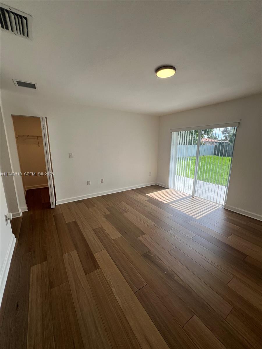 12254 Southwest 217th Street Miami, FL 33170 - Photo 25 of 40 wooden floor in an empty room with a window
