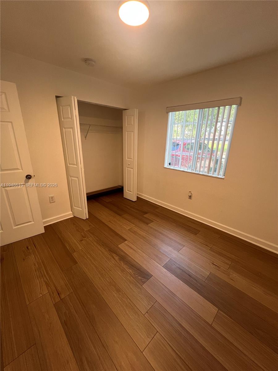 12254 Southwest 217th Street Miami, FL 33170 - Photo 30 of 40 an empty room with wooden floor and windows