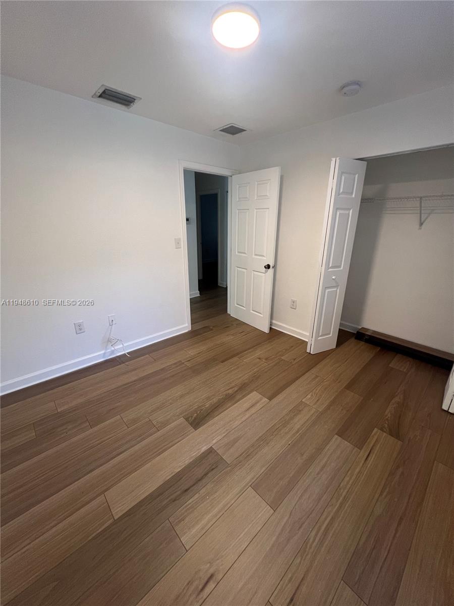 12254 Southwest 217th Street Miami, FL 33170 - Photo 31 of 40 an empty room with wooden floor and windows