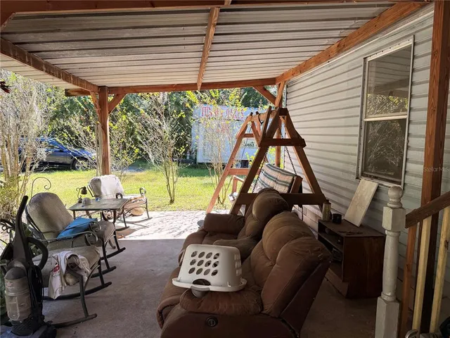 a view of a patio with table and chairs and potted plants