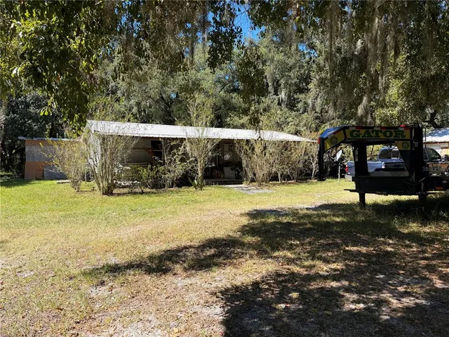 a view of a yard with basketball court