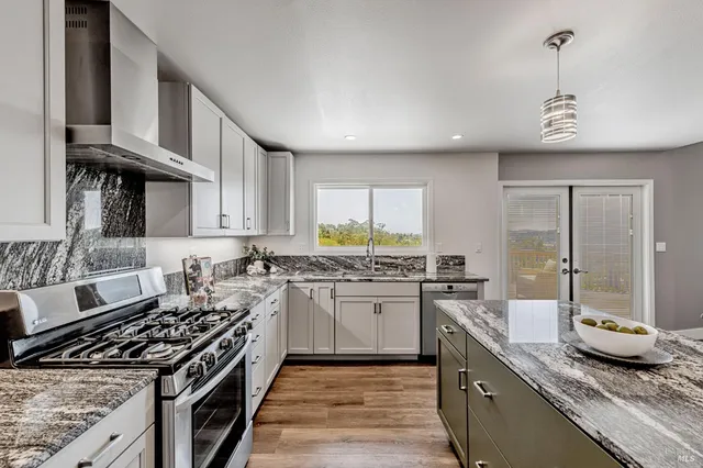 a kitchen with stove and cabinets