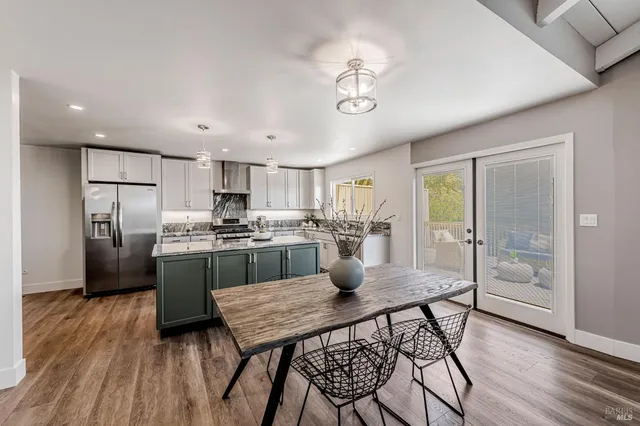 a view of a livingroom with furniture wooden floor and a chandelier