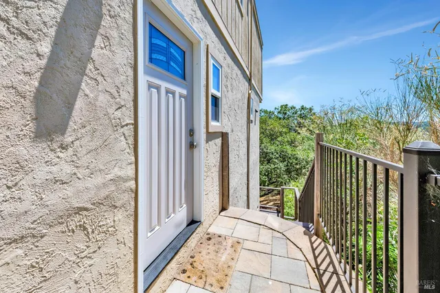 a kitchen with granite countertop a stove a sink and white cabinets