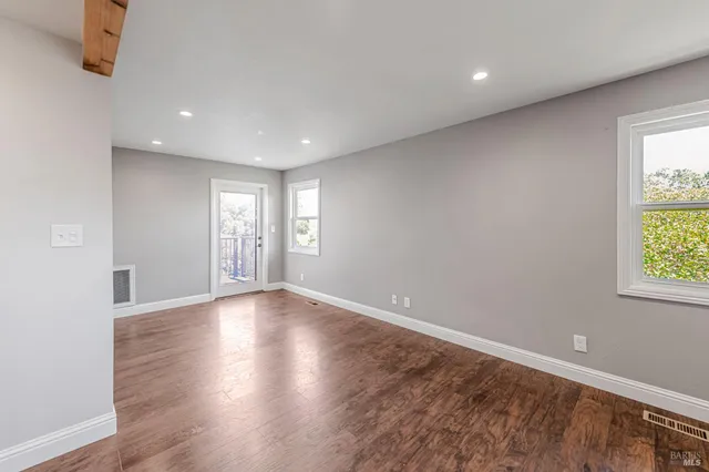 a view of a balcony with couch and chairs