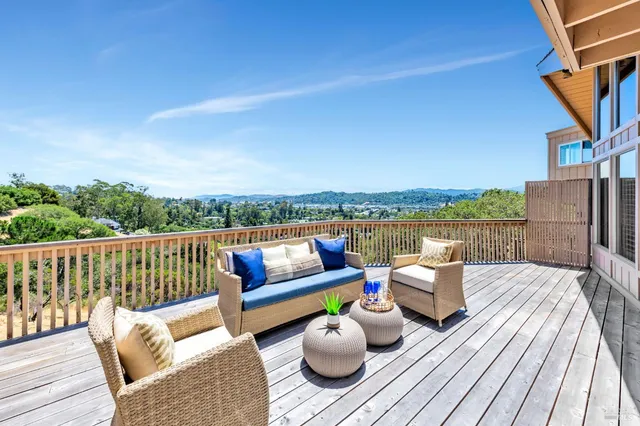 a view of a balcony with wooden floor