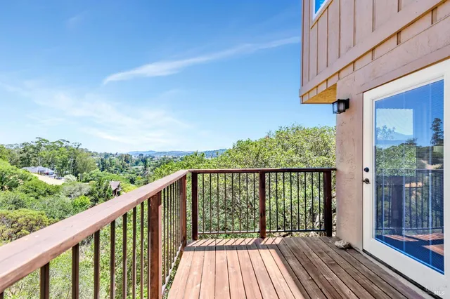 a balcony with wooden floor and fence