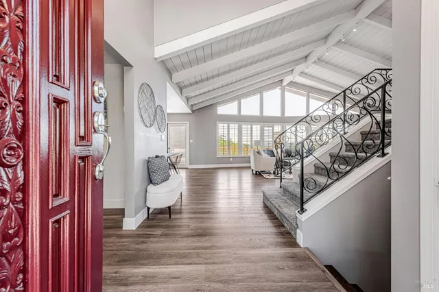 a view of entryway and hall with wooden floor