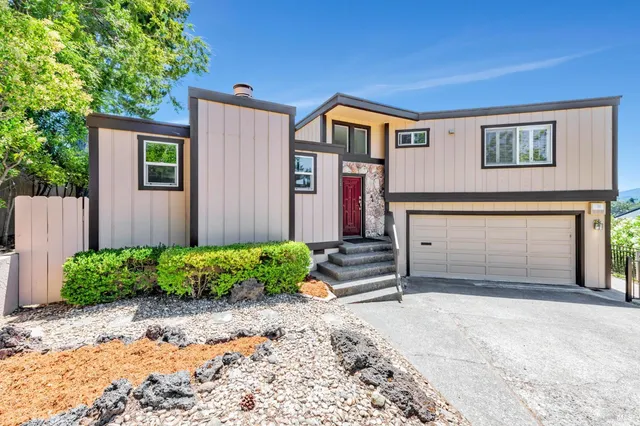 a front view of a house with a yard and garage