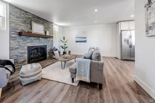 a living room with furniture and a fireplace