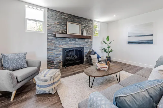 a living room with furniture and a fireplace