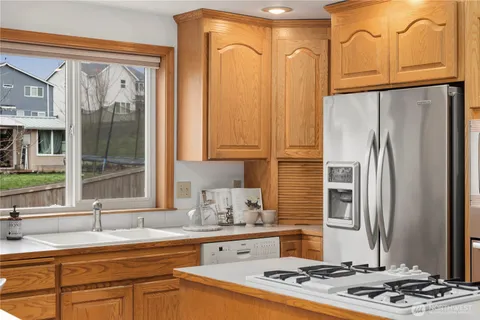 a kitchen with stainless steel appliances granite countertop a refrigerator sink and cabinets