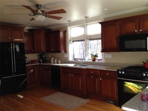 348 River Road Andover, MA 01810 - Photo 3 of 22 a kitchen with stainless steel appliances granite countertop wooden cabinets a refrigerator and a sink