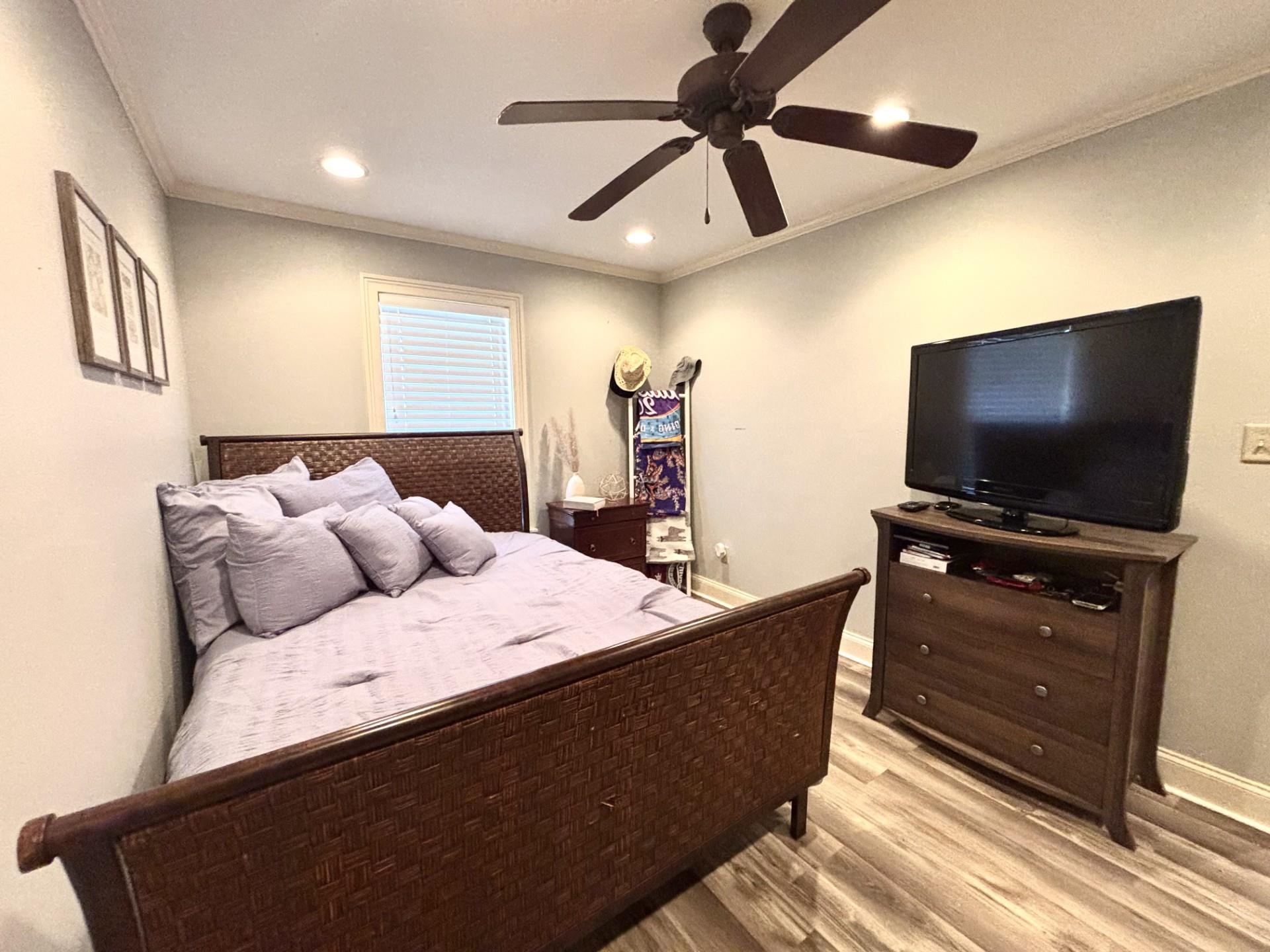 55 Cody Cove Iuka, MS 38852 - Photo 17 of 19 Bedroom with crown molding, baseboards, ceiling fan, recessed lighting, and light wood-type flooring