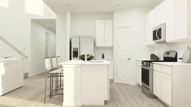 a kitchen with a stove a refrigerator and a sink