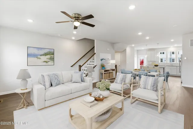 a living room with furniture and kitchen view