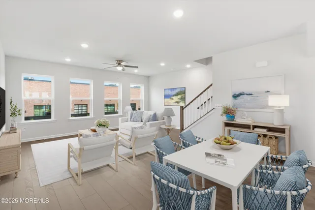 a living room with furniture two window and a table