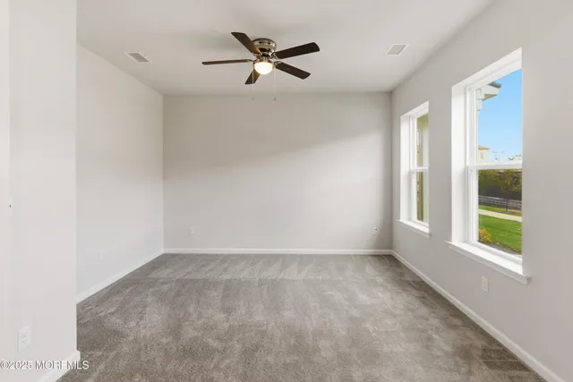 a view of a livingroom with a ceiling fan and window