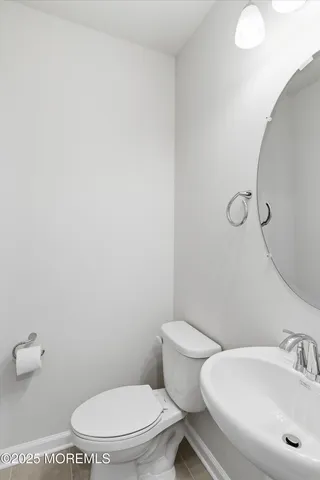a white toilet sitting next to a bathroom sink