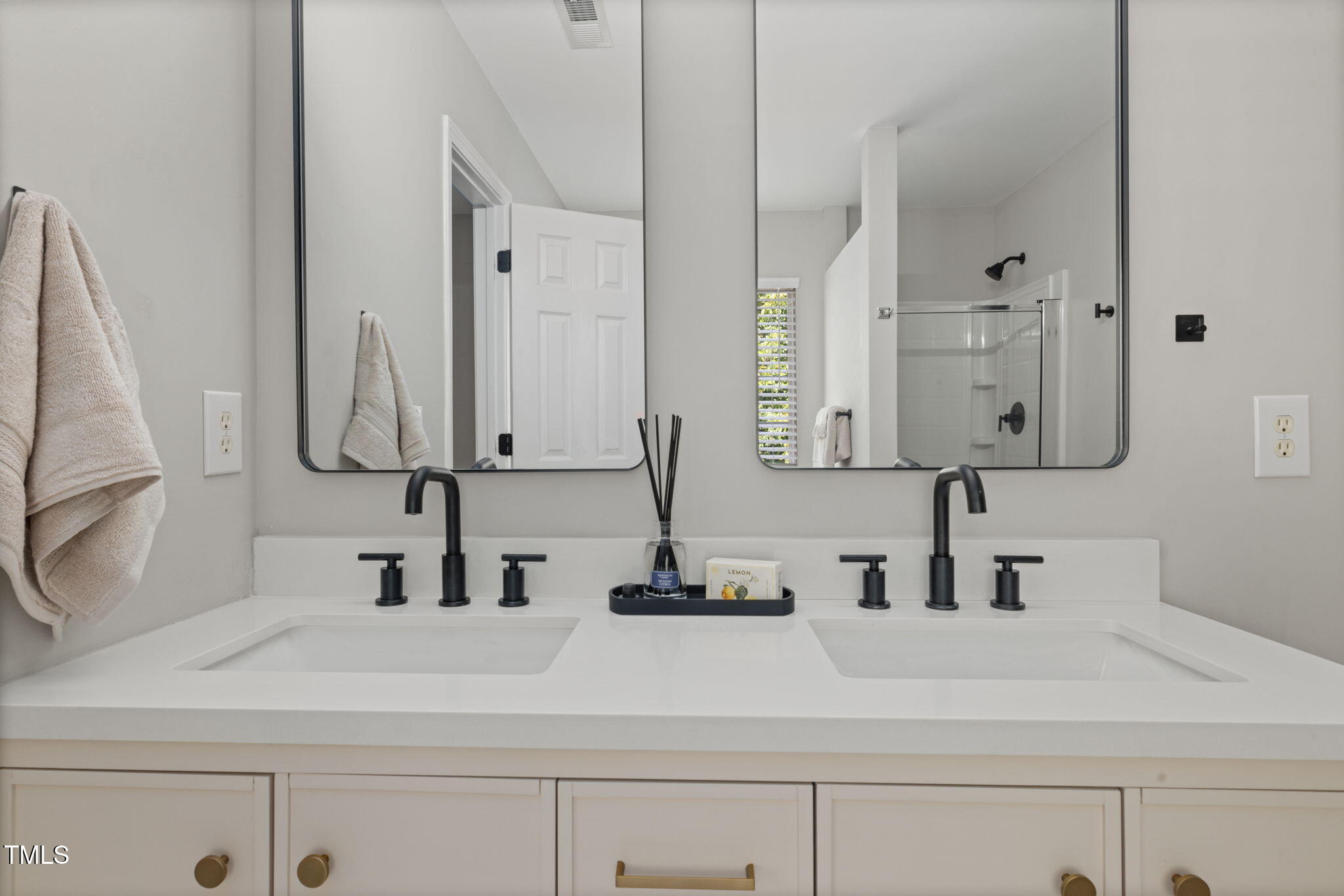 2701 Skybrook Lane Durham, NC 27703 - Photo 14 of 24 a bathroom with double vanity sink and a mirror