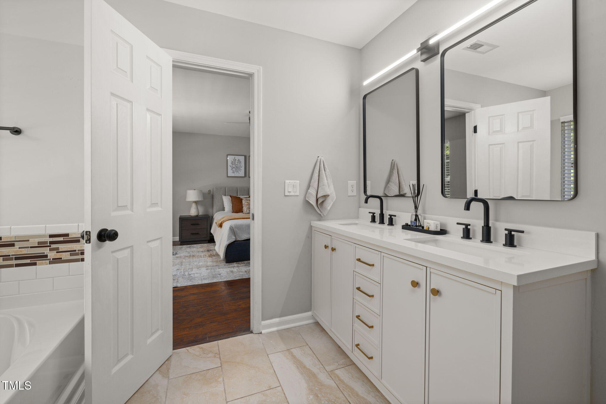 2701 Skybrook Lane Durham, NC 27703 - Photo 15 of 24 a spacious bathroom with a double vanity sink and mirror